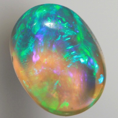 SOLID CRYSTAL OPAL Rolling flashes of green and turquoise with a purple hue